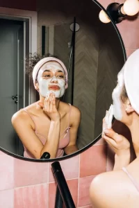 Skin care tips girl putting mask on face